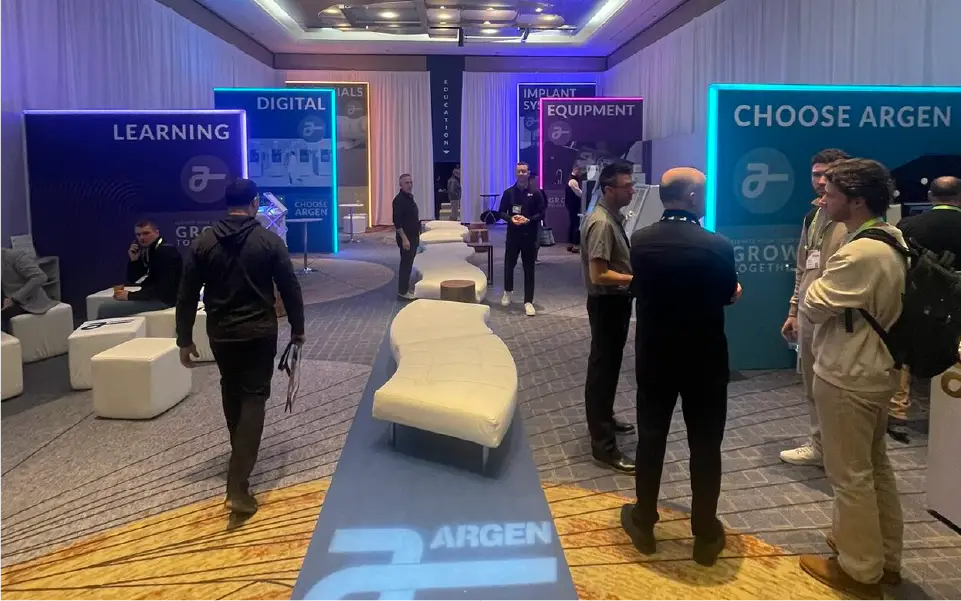 Branded registration area at the Argen corporate event for LAB ’25 with illuminated signage and sleek design.